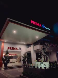 a pima gas station with a statue in front of it at Prima SR Hotel & Convention Yogyakarta in Yogyakarta