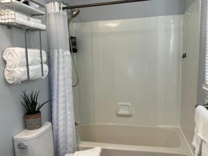 a white bathroom with a tub and a shower at Sherizee Home in Marblehead +26 photos