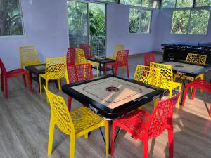 a room with tables and chairs with a ping pong table at Hotel Suryaprabha- Near Diveagar Beach in Diveagar