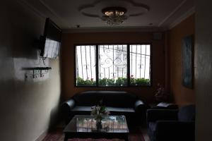 a living room with a couch and a window at Hotel El Parque HR in Fómeque
