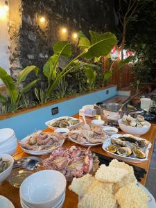 a table with many different types of food on it at Ohayo Tam Coc Homestay in Ninh Binh