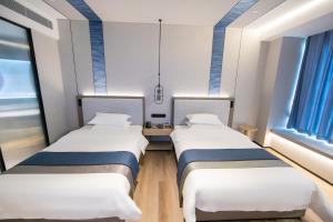 Voodi või voodid majutusasutuse Chaozhou Yuyu Hotel toas