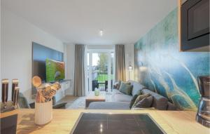 a living room with a couch and a table at 2 Bedroom Cozy Apartment In Nordstrand in Nordstrand