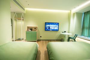 Televiisor ja/või meelelahutuskeskus majutusasutuses Chaozhou Yuyu Hotel