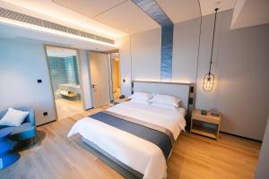 Voodi või voodid majutusasutuse Chaozhou Yuyu Hotel toas