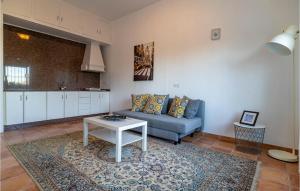 a living room with a couch and a table at Amazing Home In Las Lagunas De Mijas in Fuengirola
