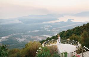 a bride and groom standing on the edge of a building at Nice Home In Kotor With Sauna in Kotor