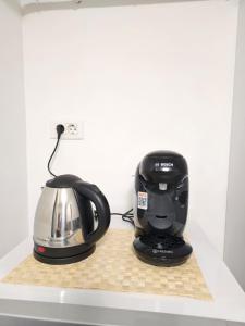 a coffee maker and a tea kettle on a counter at Luxury 1 Bedroom Apartment in Roşu
