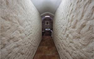a hallway in a stone wall with a table at Holiday Home Vodnjan 44 With Outdoor Swimmingpool in Vodnjan