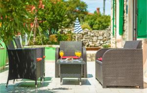 a group of chairs and a table with a drink at Holiday Home Burjaki Cr in Trgetari
