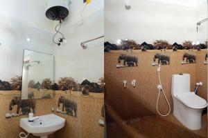 a bathroom with a toilet and a sink with elephants on the wall at Lily Residency HOMESTAY in Velankanni
