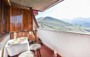 a balcony with a table and chairs with a view at Awesome Apartment In Frabosa Sottana in Frabosa Sottana
