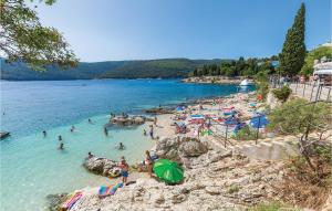a group of people in the water at a beach at Stunning Apartment In Labin With House Sea View in Labin