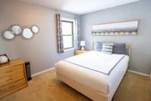 a bedroom with a bed and two mirrors on the wall at Ski On-Ski Off Okemo Mountain Getaway for Families with Pool & Hot Tubs in Ludlow