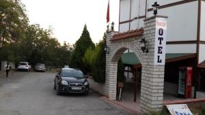 a car parked in a parking lot next to a store at Yavuzlar Hotel in Safranbolu