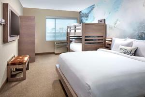 a hotel room with two bunk beds and a television at Cambria Hotel & Suites Anaheim Resort Area in Anaheim +23 photos