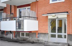a brick building with a balcony and a door at 1 Bedroom Nice Apartment In Karlshamn in Karlshamn +2 photos