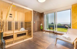 Pokój z przeszkloną kabiną prysznicową i białą kanapą w obiekcie Awesome Home In Peroj With Sauna w mieście Peroj