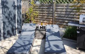 a patio with two chairs and a table with drinks at 3 Bedroom Awesome Home In Stavenisse in Stavenisse +24 photos