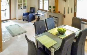 a dining room with a table and chairs and a fireplace at 3 Bedroom Beautiful Home In Kirchheim in Kirchheim