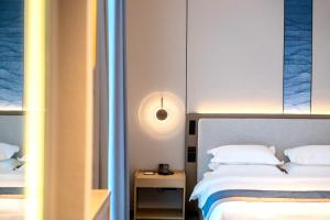 Voodi või voodid majutusasutuse Chaozhou Yuyu Hotel toas