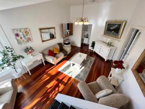 a living room with a couch and a table at La Casa Bonita Auckland in Auckland