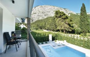 a balcony with a pool and a view of a mountain at Beautiful Home In Omis With Sauna in Omiš