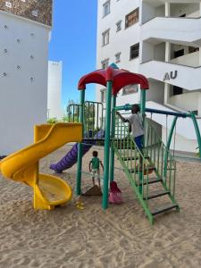 a group of children playing on a playground on the beach at Urban Bliss Homes in Mombasa