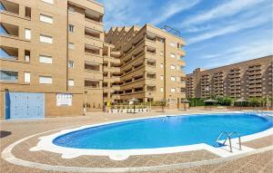 ein Swimmingpool vor zwei hohen Gebäuden in der Unterkunft 2 Bedroom Gorgeous Apartment In Oropesa in El Borseral + 10 Fotos