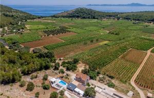an aerial view of a farm with the ocean in the background at 2 Bedroom Gorgeous Home In Smokvica in Smokvica