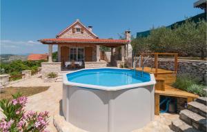 a pool in the backyard of a house at One-Bedroom Holiday Home In Nerezisca in Nerežišća