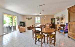 a living room with a table and a dining room at Cozy Home In Malataverne in Malataverne