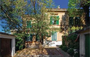 a house with a tree in front of it at Beautiful Apartment In Rijeka With Wifi in Rijeka