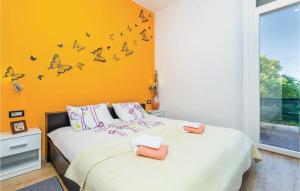 a bedroom with two beds with butterflies on the wall at Beautiful Apartment In Rijeka With Wifi in Rijeka