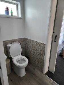a bathroom with a toilet and a window at #40 Below in Waitarere +4 photos