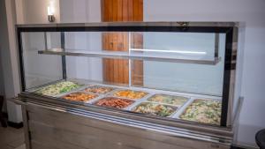 a display case filled with different types of food at Yash Rest Inn in Negombo