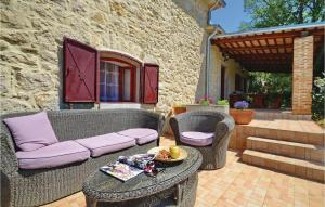 a patio with wicker chairs and a table and a couch at Holiday Home Gondolici Croatia in Labin
