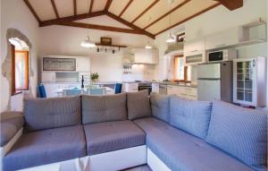 a living room with a couch and a kitchen at Holiday Home Gondolici Croatia in Labin