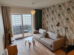 a living room with a couch and a table at Apartamenty MM - Nowa Sól in Nowa Sól