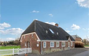 a red brick house with a black roof at Awesome Home In Bredebro With Wifi in Bredebro