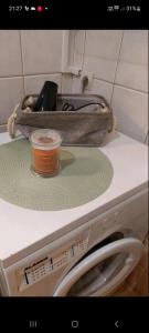 a candle sitting on top of a washing machine at Ourania's Apartment Kastoria in Mavrokhórion +8 photos