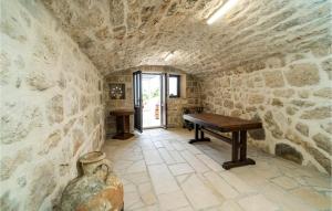 a room with a table in a stone wall at Stunning Home In Slano With Wifi in Slano +38 photos