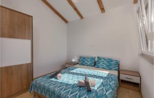 a small bedroom with a bed and a window at Gorgeous Apartment In Njivice With Wifi in Njivice +21 photos