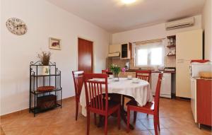 a kitchen and dining room with a table and chairs at Holiday Home Put Vrljuge Iv in Sukošan +22 photos