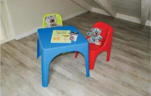 two stuffed teddy bears sitting at a blue and red chair at Gorgeous Home In Dagebüll With Sauna in Dagebüll +19 photos