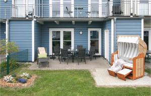 a patio with a table and chairs in front of a house at Gorgeous Home In Dagebüll With Sauna in Dagebüll