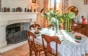a dining room with a table and a fireplace at Amazing Home In Bassillac-Et-Auberoche in Le Change