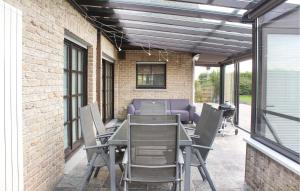 a patio with a table and chairs and a building at 4 Bedroom Gorgeous Home In Groede in Groede