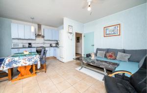 a living room with a couch and a table at Stunning Apartment In Barbariga in Barbariga