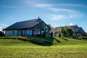 a house on a grassy hill with a building at Mein-Ostseeplätzchen Haus am Meer 8 in Niesgrau